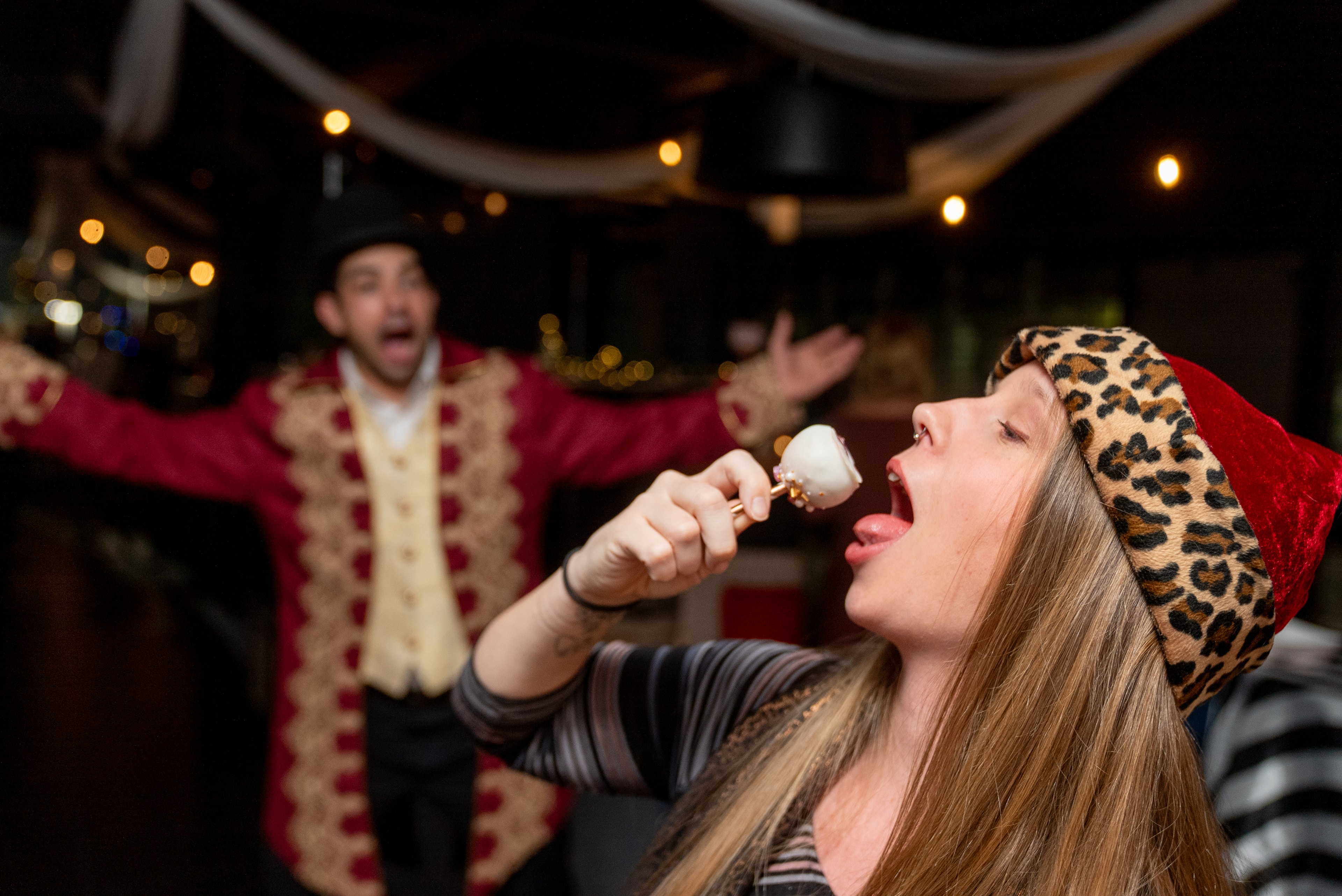 Woman eating candy cane at the holiday party