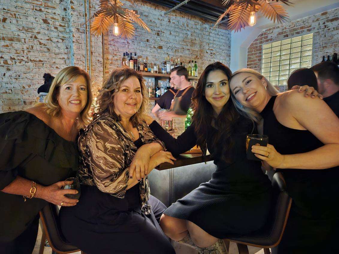 Women friends posing at upscale bar